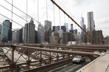 The skyline of Lower Manhattan as seen from the Brooklyn Bridge. The Brooklyn Bridge roadway is also visible.