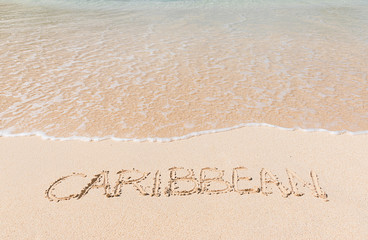 Caribbean beach.
Text written in the sand.