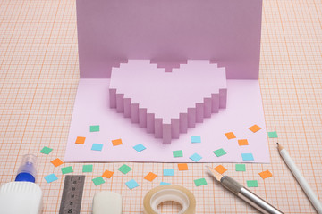 Making  pop-card  in the form of heart. Card and tools  used for its construction on graph paper.
