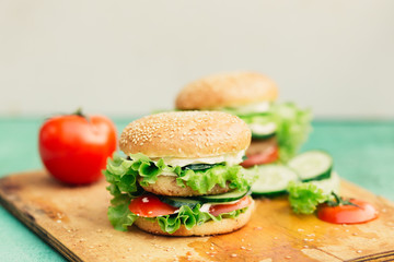 Home made burgers on wooden background