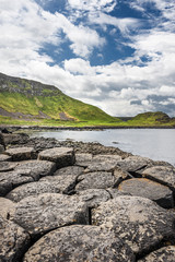 Giant's Causeway, Northern Ireland: Coastal scenic view over rocks, Atlantic and hills in the background. Since 1986 this place is part of the UNESCO World Heritage Site.
