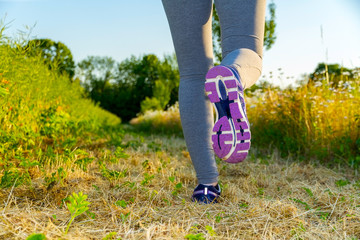 Woman running at sunset in a field