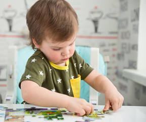 Little boy playing puzzle