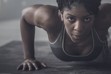 Woman doing push-ups in gym