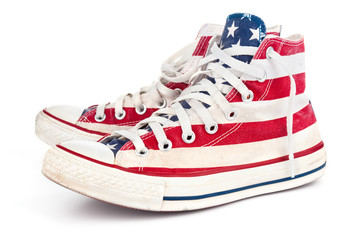 Pair of red gumshoes on white background