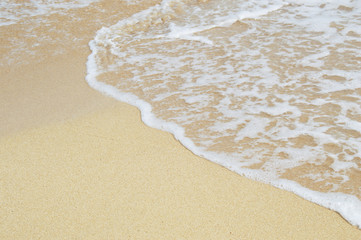 Fototapeta na wymiar Shore of the beach. Sand and sparkling sea.