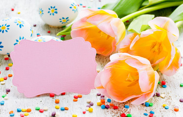 Easter concept blank card, yellow tulips, painted eggs