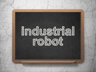 Manufacuring concept: Industrial Robot on chalkboard background