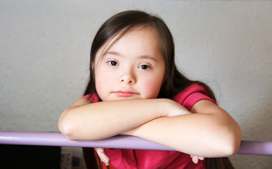 Portrait of little girl on the backgroung of the grey wall
