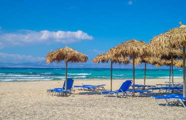 Chrisi (Chrysi) island beach background with straw sunshades, Cr