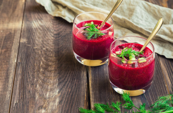 Beetroot gazpacho soup with cucumber and dill in glasses