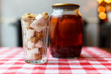 White and brown sugar in a glass beaker and the Bank with compot