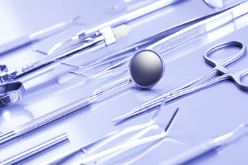 Professional dental mirror and other tools in a sterile medical light