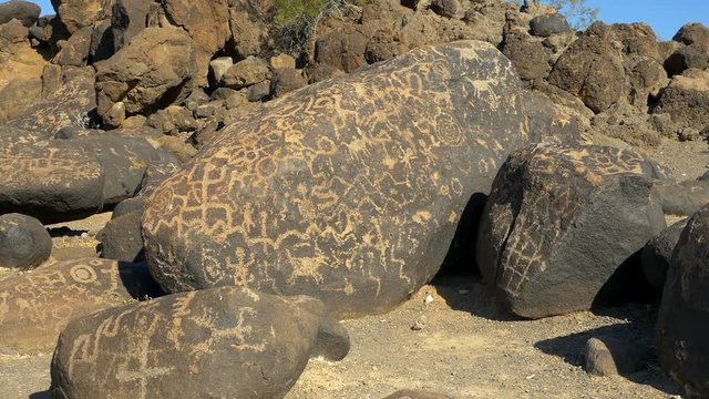 Petroglyphs etched into desert boulders