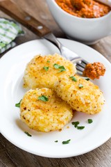 Rice croquette crispy breaded with red pesto sauce, tasty vegan