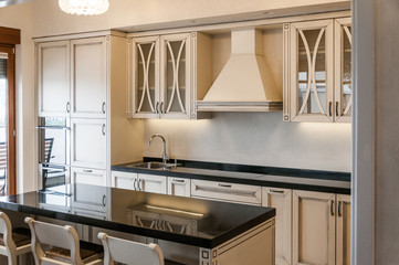 White contemporary kitchen with island and bar stools