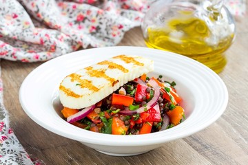 Fresh healthy salad with tomatoes, lentils, grilled cheese