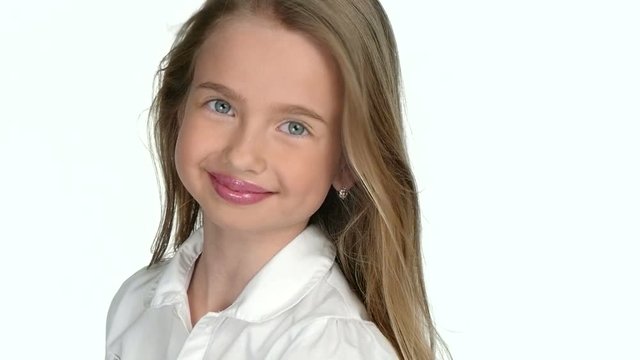 Teenage girl blonde smiling and posing  on white background,slow motion