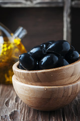 Black olive and olive oil on the wooden table