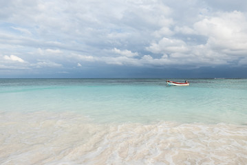 boat on a white tropical beach in the caribbean sea