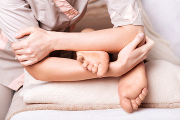 Fototapeta na wymiar Woman having therapeutic foot massage in spa salon, closeup