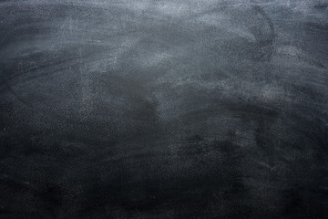 Dirty blackboard with chalk traces, black background