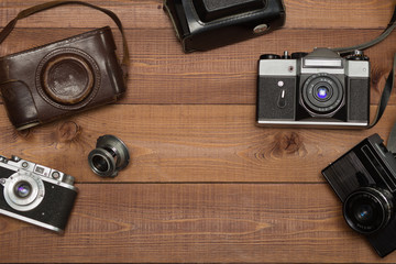 three vintage camera on the wooden background