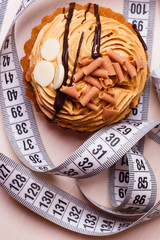 cupcake with measuring tape on table