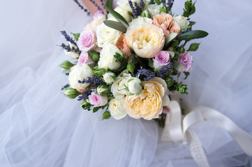Colorful bouquet of the bride with roses, lavender and peonies, decoration for wedding