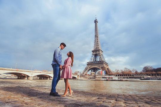 honeymoon in Paris, young beautiful couple on Eiffel Tower background
