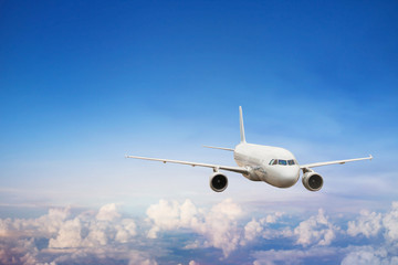 Fototapeta na wymiar travel by plane, international flight, airplane flying in blue sky above the clouds