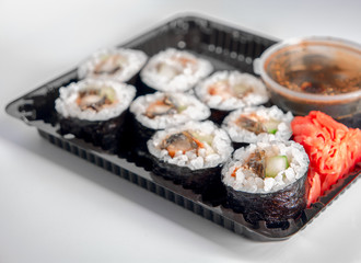 Open Sushi delivery box on white background. Angle view.