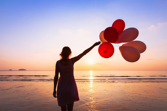 imagination and creativity, girl with multicolored balloons at sunset with copyspace, inspiration concept