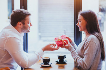 gift for valentines day, birthday or anniversary, man and woman in cafe, couple portrait