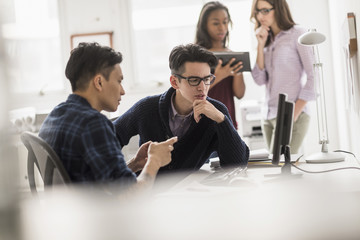 Businessmen working together in office