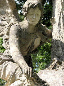 ancient stone sculpture girl-angel with wings mourn for the dead