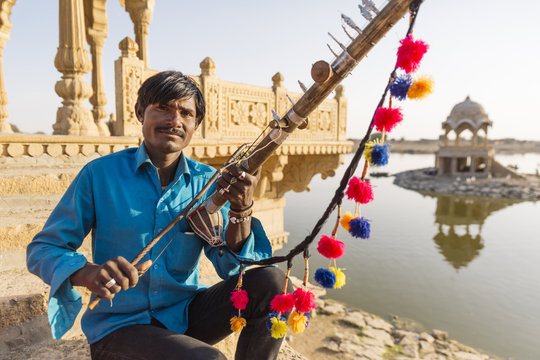 Man holding traditional instrument, Rajasthan, India