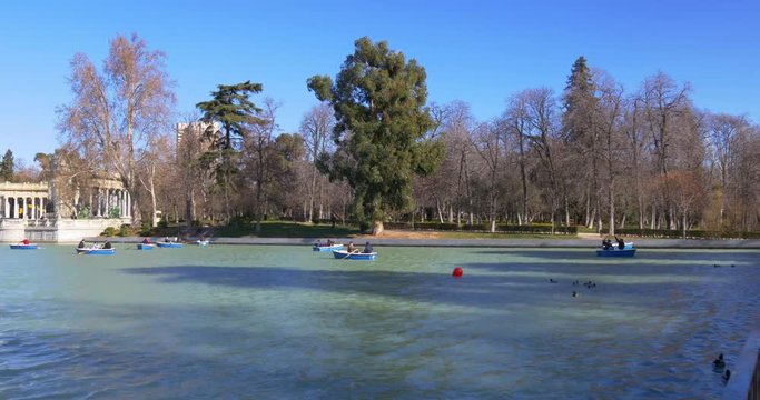 buen retiro park sun light pond boats riding 4k spain
