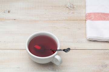 Cup of red tea with spoon