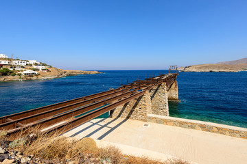 Old gantry projecting out to sea at Loutra port in Kythnos, Greece