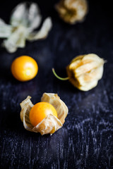 Closeup orange organic cape gooseberries on wooden background