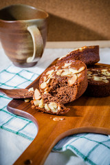 Homemade delicious fresh chocolate and almonds cake on wooden ta