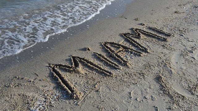The inscription Miami on sand.