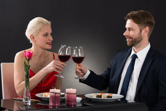 Young Couple Toasting Wine In A Restaurant