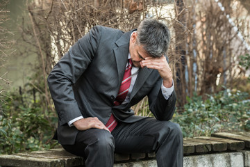 Businessman Sitting On The Bench Outdoors