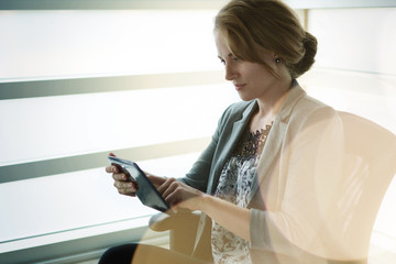 Filtered portrait of an executive business woman writing on a glass wall at sunset