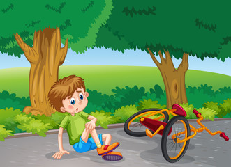 Obraz na płótnie Canvas Boy falling down from bike in the park