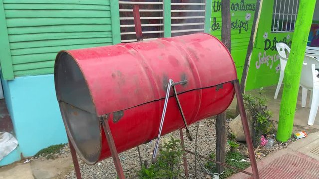 Red homemade smokers grill full of tasty meat, in las terrenas, samana, domenican republic