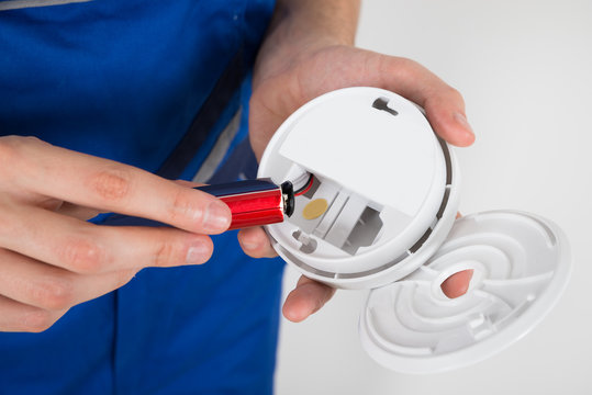 Electrician Holding Smoke Detector
