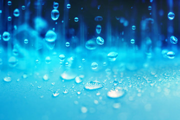 Naklejka na ściany i meble Close up rain water drops falling on blue sponge surface 